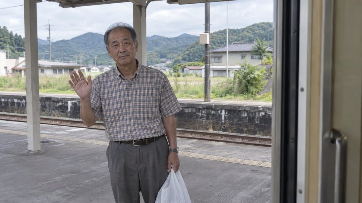 Elderly Man Waving at Rural Station